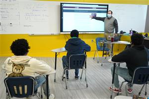 Teacher pointing to Whiteboard 